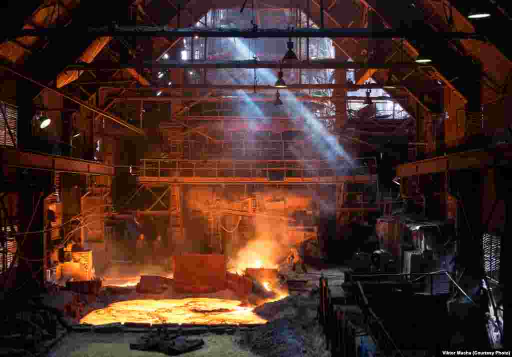 The working floor of Kosaya Gora Iron Works, Russia. Shortly after making this image, Macha says he slipped going down a narrow stairwell and slashed open his arm. Bleeding heavily, he made his way to a nearby hospital. &quot;It was not good, the hospitals in this part of Russia are in very bad condition.&quot;&nbsp;