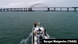 A Russian patrol boat approaches the Kerch Strait Bridge.