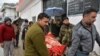 An injured man is carried on a stretcher at a hospital in the Indian-administered Kashmir's frontier town of Mendhar on March 2.