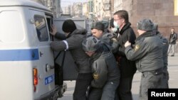 Russian police detain a protester during a rally in the far eastern city of Vladivostok on March 31.
