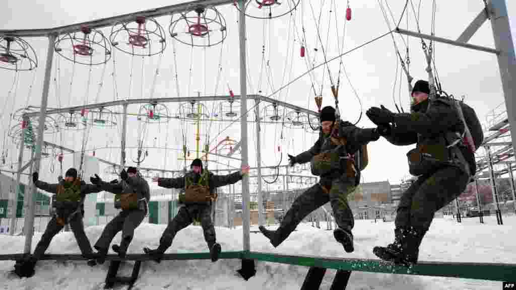 Orthodox priests of the Russian Airborne Forces undergo practical training before parachute jumps at the Ryazan Higher Airborne School outside Moscow on March 20. (AFP/Andrey Smirnov) 