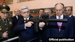 Armenia - President Serzh Sarkisian examines an Armenian-made rifle during a visit to the Defense Ministry in Yerevan, 18Apr2014.