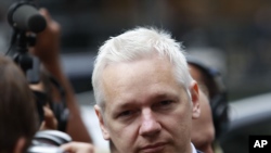 WikiLeaks founder Julian Assange is surrounded by members of the media as he arrives at Britain's Royal Courts of Justice for his extradition appeal in central London on July 13.