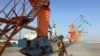 A Pakistani soldiers guarding port cranes in Gwadar, a seaport in Balochistan. 