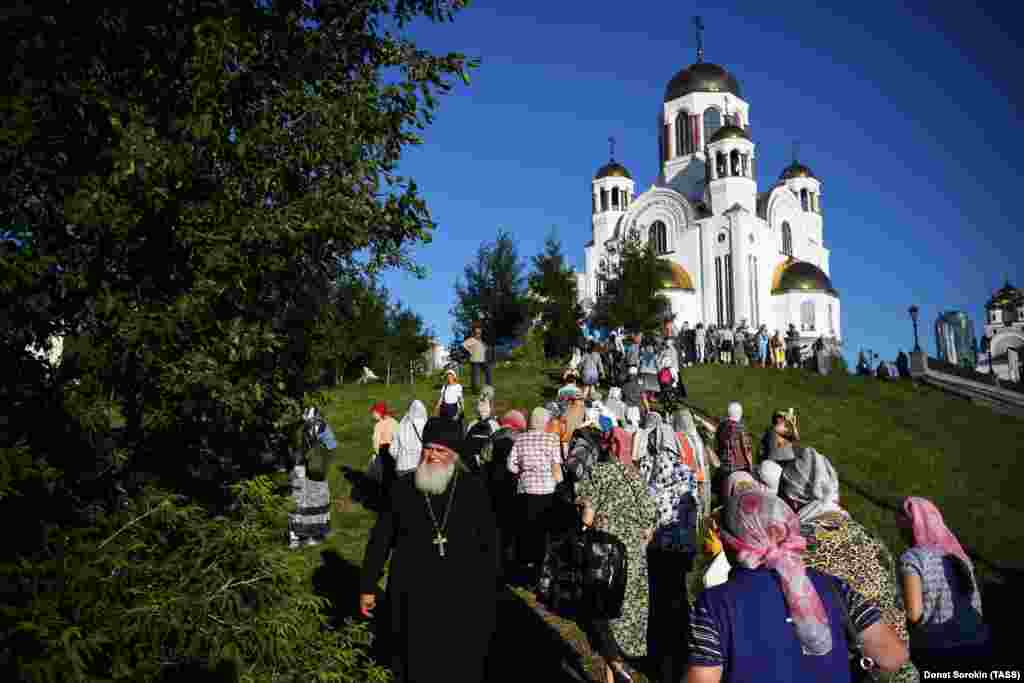 Marchers at the church marking the spot where the royal family were killed. The church was built on the site in the early 2000s. The house in which the murders took place was destroyed in 1977. 