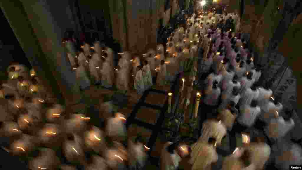 Catholic clergy hold candles during a procession at the traditional Washing of the Feet ceremony at the Church of the Holy Sepulchre ahead of Easter celebrations in Jerusalem. (Reuters/Darren Whiteside)