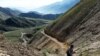 Afghan miner Morad Ali walks on a mountainside near the village of Qara Zaghan in Baghlan Province. 