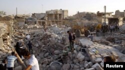 Men search for bodies of people after a Syrian air strike on Azaz.