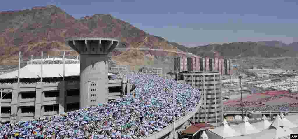 Pilgrims arrive to throw pebbles at pillars during the Jamarat ritual in Mina near the holy city of Mecca, during the 2012 hajj.