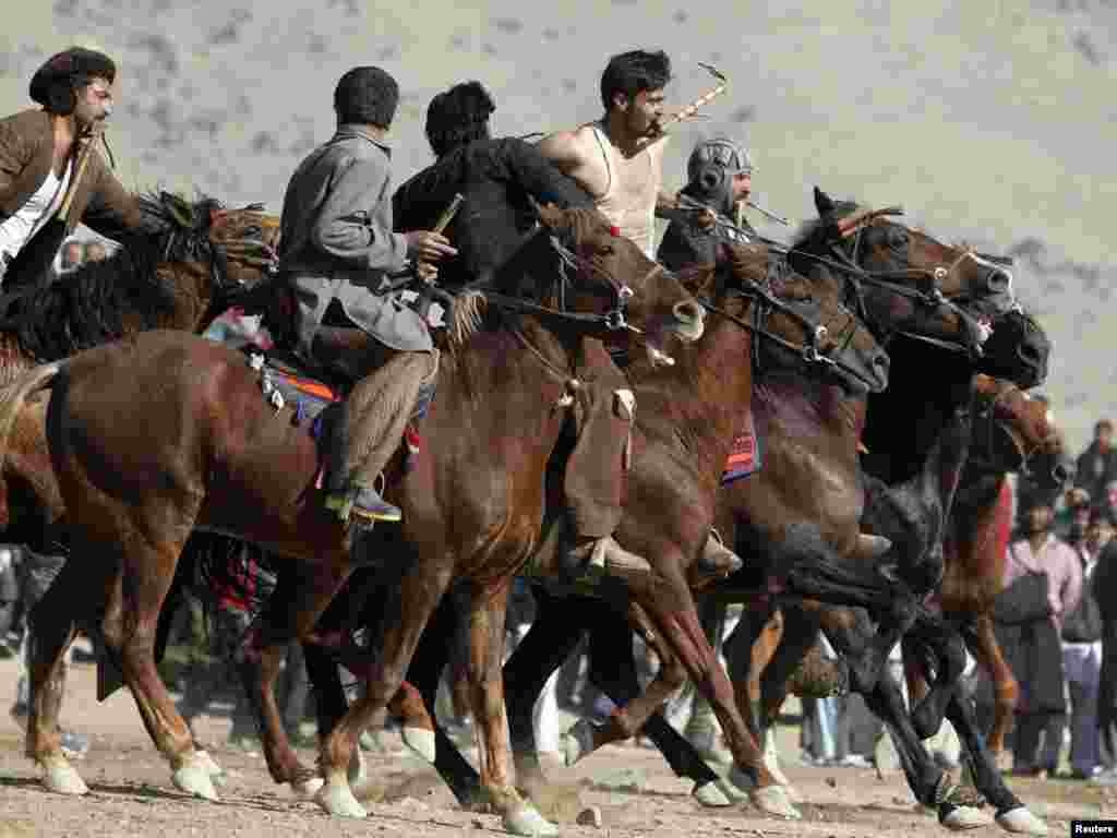 Afghan horsemen compete during a game of buzkashi in Kabul on December 3. The Afghan national sport is played between two teams of horsemen competing to pick a headless calf, goat, or sheep carcass from the ground and throw it into a scoring circle. Photo by Omar Sobhani for Reuters