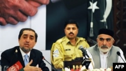 Head of the Afghan delegation, Abdullah Abdullah (left) speaks during a joint press conference with Pakistani delegation head Owais Ghani