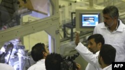 Iranian President Mahmud Ahmadinejad (gesturing) tours a nuclear-fuel-making plant during its inauguration ceremony in the central province of Isfahan in April 2009.