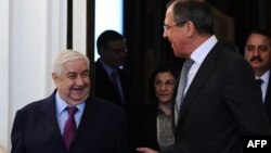 Russian Foreign Minister Sergei Lavrov (right) speaks with his Syrian counterpart, Walid al-Muallem, during their meeting in Moscow.