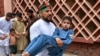 A volunteer carries an injured boy to a hospital, following multiple bomb blasts in Jalalabad on August 19.