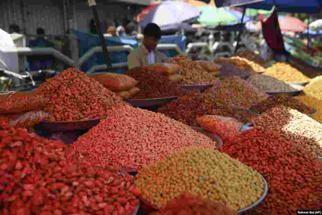 Mounds of dry fruits and a vendors await customers at a Kabul market on May 22 ahead of the upcoming Eid al-Fitr holiday.