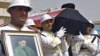 An honor guard carries the coffin of Abdul Aziz al-Hakim upon its arrival at Baghdad International Airport.