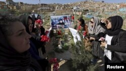 FILE: Afghan women rights activists protest on the grave of 27-year-old woman, Farkhunda, who lynched by a mob in Kabul in Kabul in March 2015.