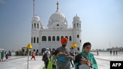 Sikh pilgrims at the Gurdwara Darbar Sahib in Kartarpur on September 22. The Pakistani site is so close to the border that its white dome and four cupolas can be seen from India.
