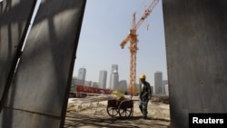 A laborer works at a construction site in Beijing's central business district (file photo)