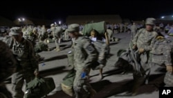 U.S. soldiers line up to have luggage checked by U.S. Customs at the Transit Center in Manas, Kyrgyzstan, a key supply route for international military operations in Afghanistan. (file photo)