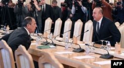 Russian Foreign Minister Sergei Lavrov (left) meets with his Turkish counterpart, Mevlut Cavusoglu, in Moscow on December 20.