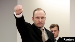 Norwegian mass killer Anders Behring Breivik give a clenched-fist salute as he arrives in court for the second day of his terrorism and murder trial in Oslo on April 17. 