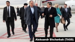 Russian Foreign Minister Sergei Lavrov (center) is welcomed by his Turkmen counterpart, Rashid Meredov (right), upon his arrival in Ashgabat on February 5.