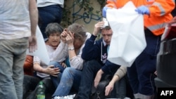 Rescue workers help victims of the Prague blast on April 29.