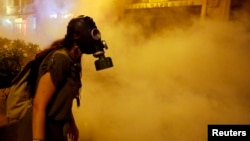 Turkey-- A protestor wears a gas mask during clashes with police near Taksim Square in Istanbul June 22, 2013