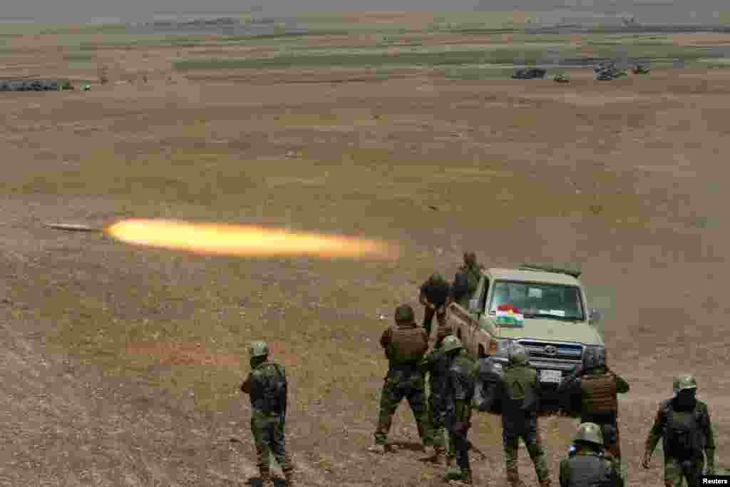 Kurdish Peshmerga forces fire a rocket toward Islamic State militants, southeast of Mosul, Iraq. (Reuters/Azad Lashkari)