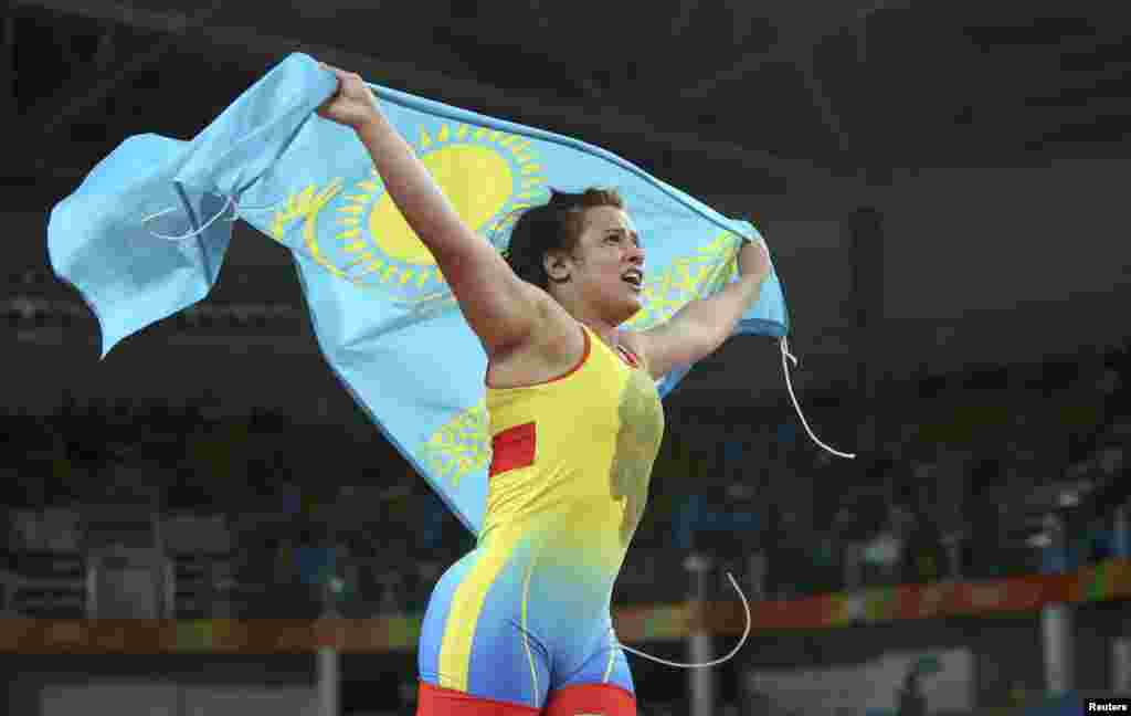 Yekaterina Larionova of Kazakhstan hoists her country&#39;s flag after winning bronze in the women&#39;s 63kg freestyle wrestling competition.&nbsp;