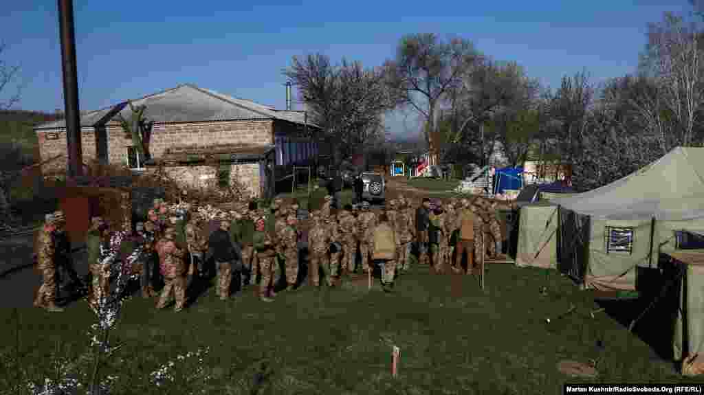 Ukrainian soldiers line up to vote in a special ballot station in the village of Krymske in the Luhansk region during the April 21 presidential runoff vote.