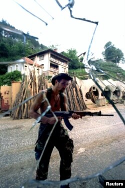 A Serb searching for Muslim fighters inside Srebrenica on July 13.