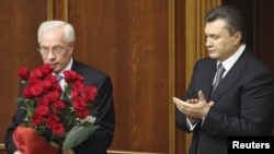 It was unclear whether President Viktor Yanukovych (right) planned to reappoint Mykola Azarov, who won a parliamentary seat in the October elections. (file photo)