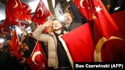 Dutch Turkish demonstrators hold Turkish flags as they gather outside the Turkish Consulate in Rotterdam on March 11 after the Netherlands refused Turkish Foreign Minister Mevlut Cavusoglu permission to land for a rally to gather support for a referendum on boosting the Turkish president's powers.