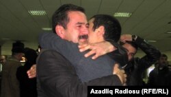 People greet loved ones returning from Egypt today at Baku airport.