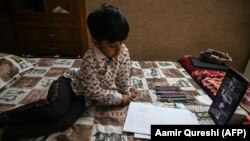 A Pakistani student attends an online class at his home in Islamabad during the lockdown. (file photo)