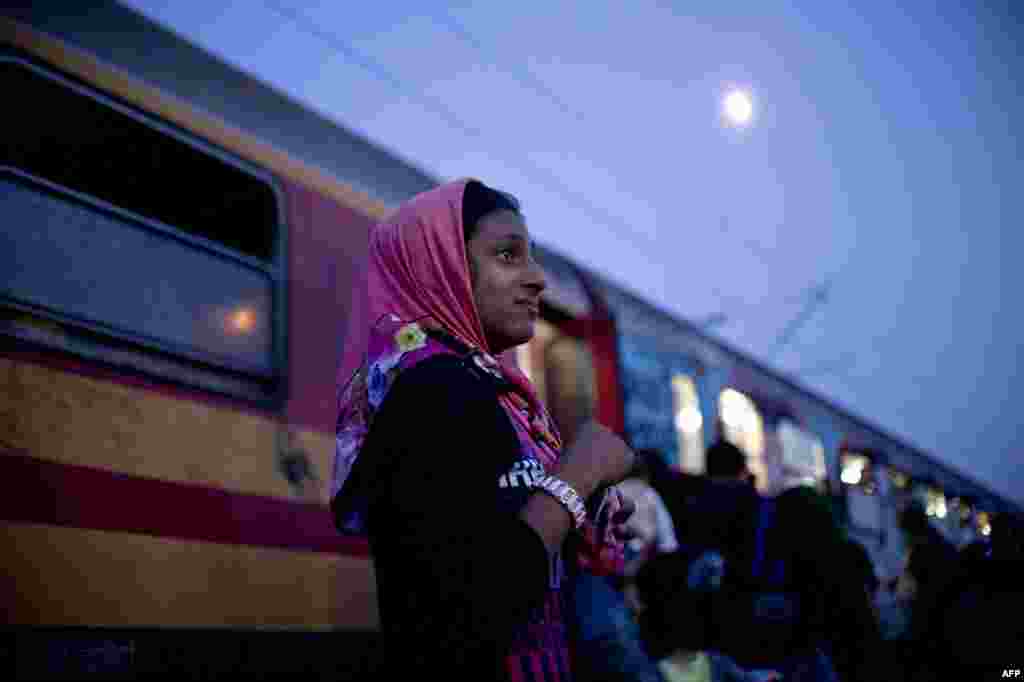 A Syrian girl cries after losing site of her family while migrants and refugees board a train heading to Serbia near the Macedonian-Greek border. (AFP/Nikolay Doychinov)