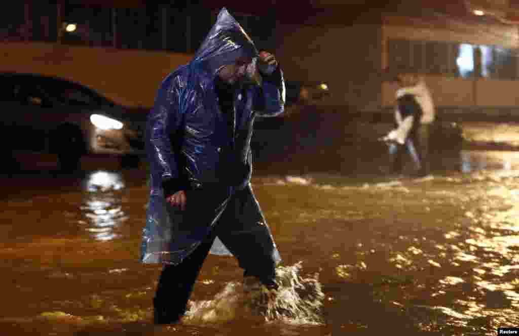 A man walks along a flooded street in the Russian city of Sochi on September 24 after the Black Sea resort was hit by torrential rain. (Reuters/Maksim Shemetov)