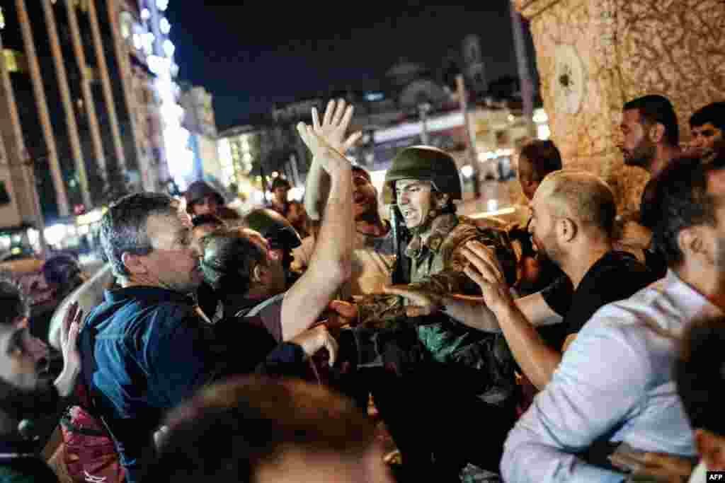 In Istanbul, things became increasingly tense as civilians swarmed soldiers who had taken up posts on Taksim Square.&nbsp;