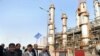 Iranian President Mahmoud Ahmadinejad (C) tours the Abadan oil refinery during the inauguration of a petrol making unit in the southwestern city of Abadan on May 24, 2011 where an accidental blast at the refinery killed one person and wounded 25 during th