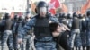 A riot police office detains a female protester during an opposition protest in Moscow's Bolotnaya Square in May 2012. 