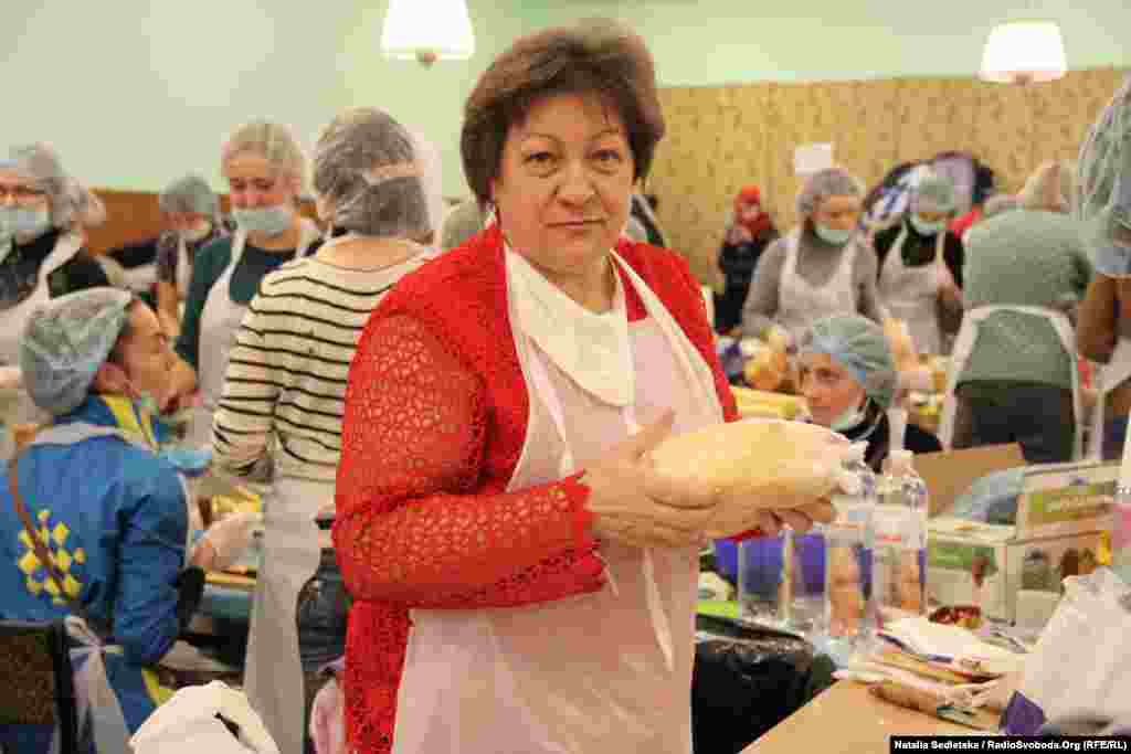 Lyubov Stepanivna, a retired sanitation inspector, checks all the food supplies to make sure no products are expired and that all the preparations meet hygienic standards.