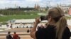 A visitor takes a photo of the view of Moscow's skyline from the new Zaryadye Park on September 15. 