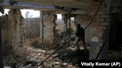 A Ukrainian soldier moves through a destroyed building in the town of Avdiyivka in the Donetsk region.