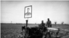 A poster of Soviet leader Josef Stalin atop one of the first tractors photographed at work in the fields of Uzbekistan.<br><br>In early 1925, the region of today’s Uzbekistan was declared a republic of the Soviet Union. The Soviet takeover marked a period of ruthless transformation, which included executions of Uzbek political prisoners as well as literacy programs and industrialization.