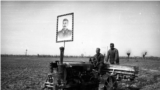 A poster of Soviet leader Josef Stalin atop one of the first tractors photographed at work in the fields of Uzbekistan.<br><br>In early 1925, the region of today’s Uzbekistan was declared a republic of the Soviet Union. The Soviet takeover marked a period of ruthless transformation, which included executions of Uzbek political prisoners as well as literacy programs and industrialization.