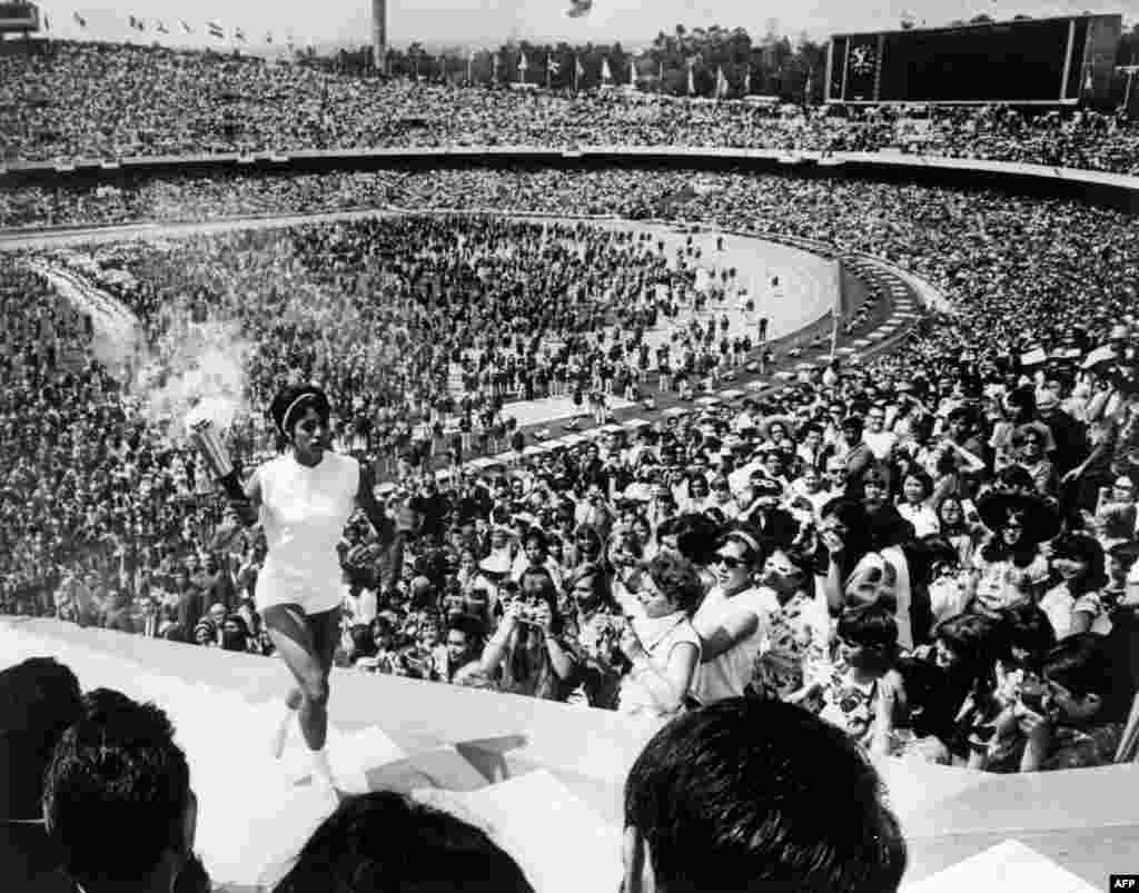 Mexican hurdler Norma Enriqueta Basilio de Sotelo becomes the first woman to light the Olympic flame in Mexico City in October 1968.