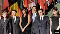 The German, U.S., and French leaders with their spouses in Baden-Baden on April 3