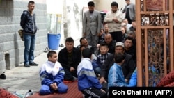 Families gather at a mosque for Friday Prayers in Urumqi, the capital of Xinjiang.